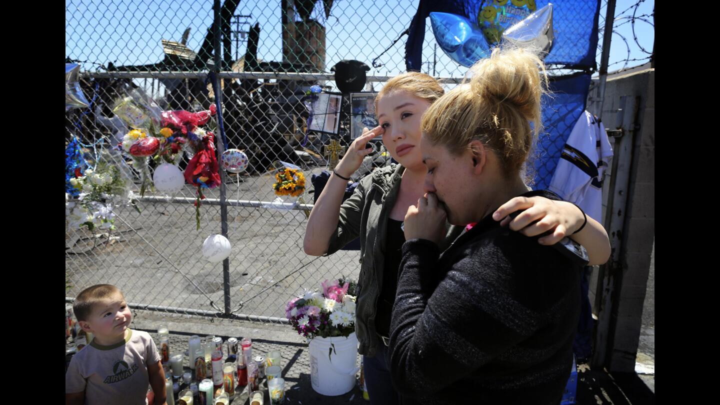 Rocio Guerrero and her mother, Atzimba Zamudio, visit the memorial where three teens were killed in a firebombing at Cheque Tires in South El Monte.