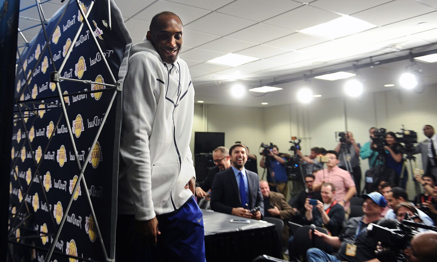 Kobe Bryant leaves a news conference with a laugh after a game against the Thunder in Oklahoma City on April 11.