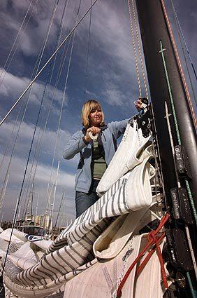 Abby Sunderland adjusts her sails as she prepares to sail her 40-foot boat Wild Eyes out of Marina del Rey for a sea trial to get the ship tuned and ready. Abby began her sail with riggers and communication experts on board who dialed in the equipment. The team then departed her ship as she set sail for a solo overnight trial, which was the first time she was alone on the boat.