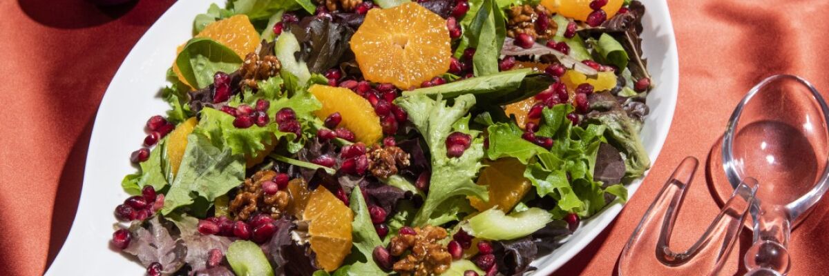 Citrus and pomegranate seeds add bright colors and flavors to a mixed green salad.
