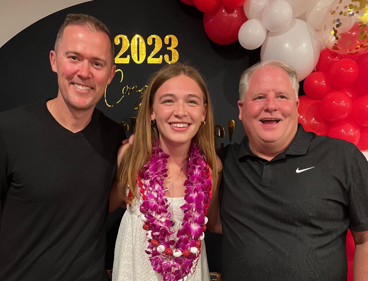 USC football coach Lincoln Riley, left, and UCLA football coach Chip Kelly, right, pose for a photo with Mackenzie McGovern.
