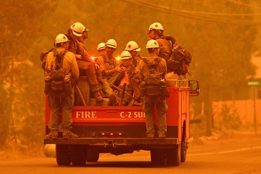 Firefighters arrive at the scene as flames from the Caldor fire push into South Lake Tahoe, California on August 30, 2021. - At least 650 structures have burned and thousands more are threatened as the Caldor fire moves into the resort community of South Lake Tahoe, California. Thousands of people were ordered to evacuate Monday as a huge wildfire loomed over a major US tourist spot, filling the air with choking smoke. The Caldor Fire has already torn through more than 270 square miles (700 square kilometers), razing hundreds of buildings. (Photo by JOSH EDELSON / AFP) (Photo by JOSH EDELSON/AFP via Getty Images)