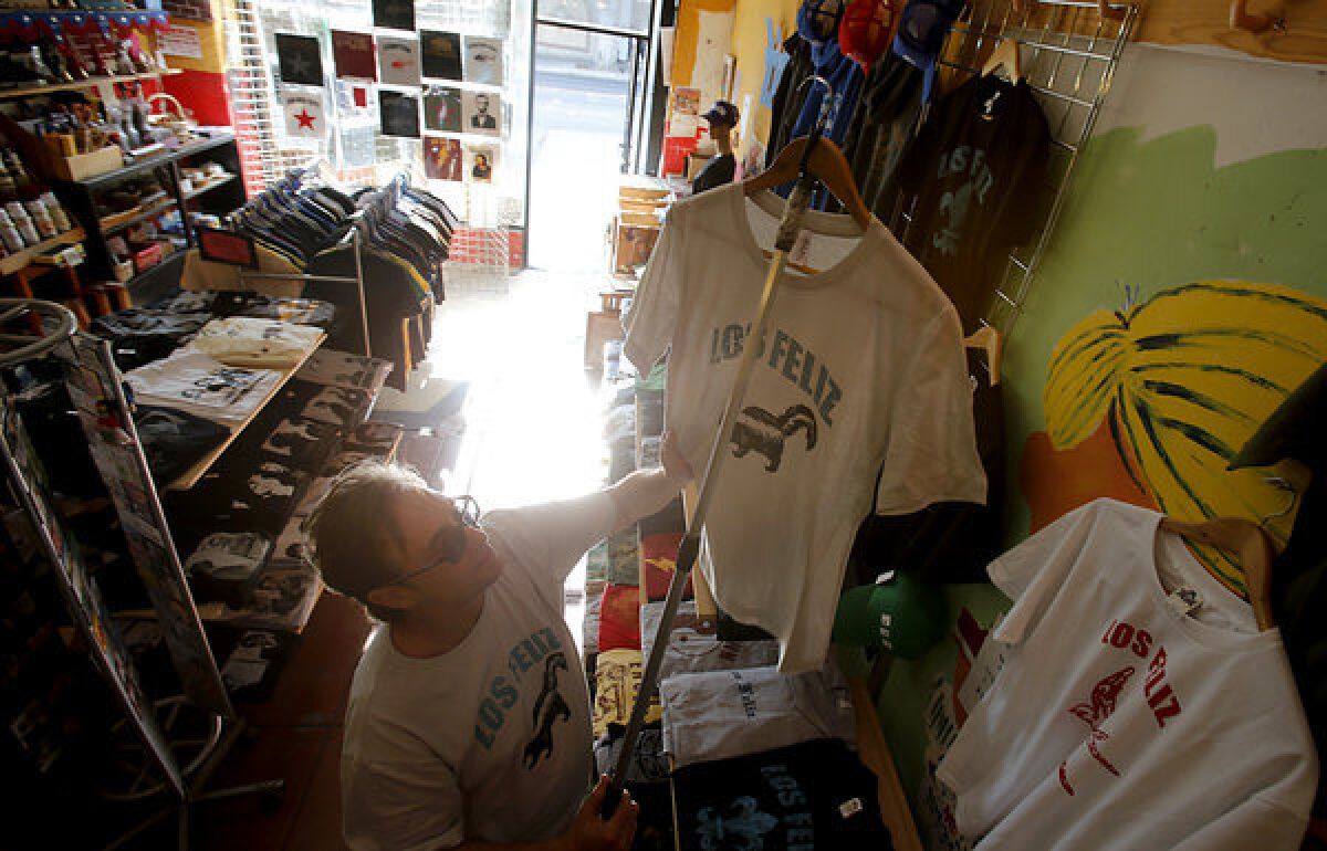 Bill Wyatt hangs "Los Feliz" T-shirts at his shop, Y-Que Trading Post, in Los Feliz. On an online message board called "Southern California-isms," a former Los Feliz resident described an urge to slap everyone who uses the Spanish pronunciation, hoping to "bring them back to reality."