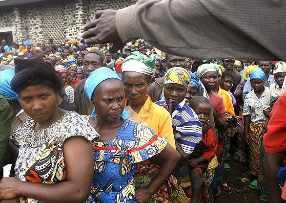 In Ntamugenga in embattled eastern Congo, displaced Congolese wait for aid. More than 2,500 families received water containers, blankets and buckets and soap from the Catholic Agency For Overseas Development.