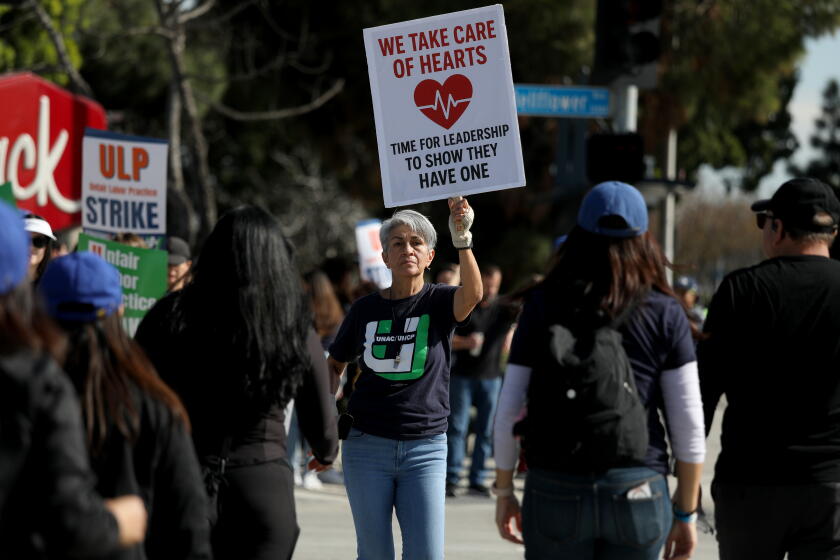 DOWNEY, CALIFORNIA - JANUARY 26: Doris Colon, registered nurse, along with other registered nurses and health care professionals participate in an unfair labor practice (ULP) strike at Kaiser Permanenteon Monday, Jan. 26, 2026 in Downey, California. 31,000 frontline registered nurses and health care professionals will begin an unfair labor practice (ULP) strike at Kaiser Permanente facilities across California (Gary Coronado / For The Los Angeles Times)