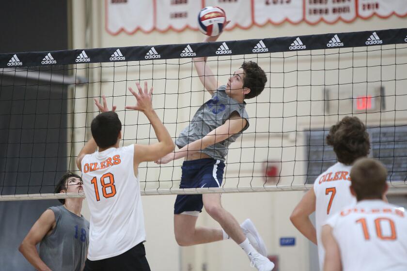Corona del Mar's Matt Olson (23) goes up for a kill during Surf League volleyball match against Huntington on Saturday.