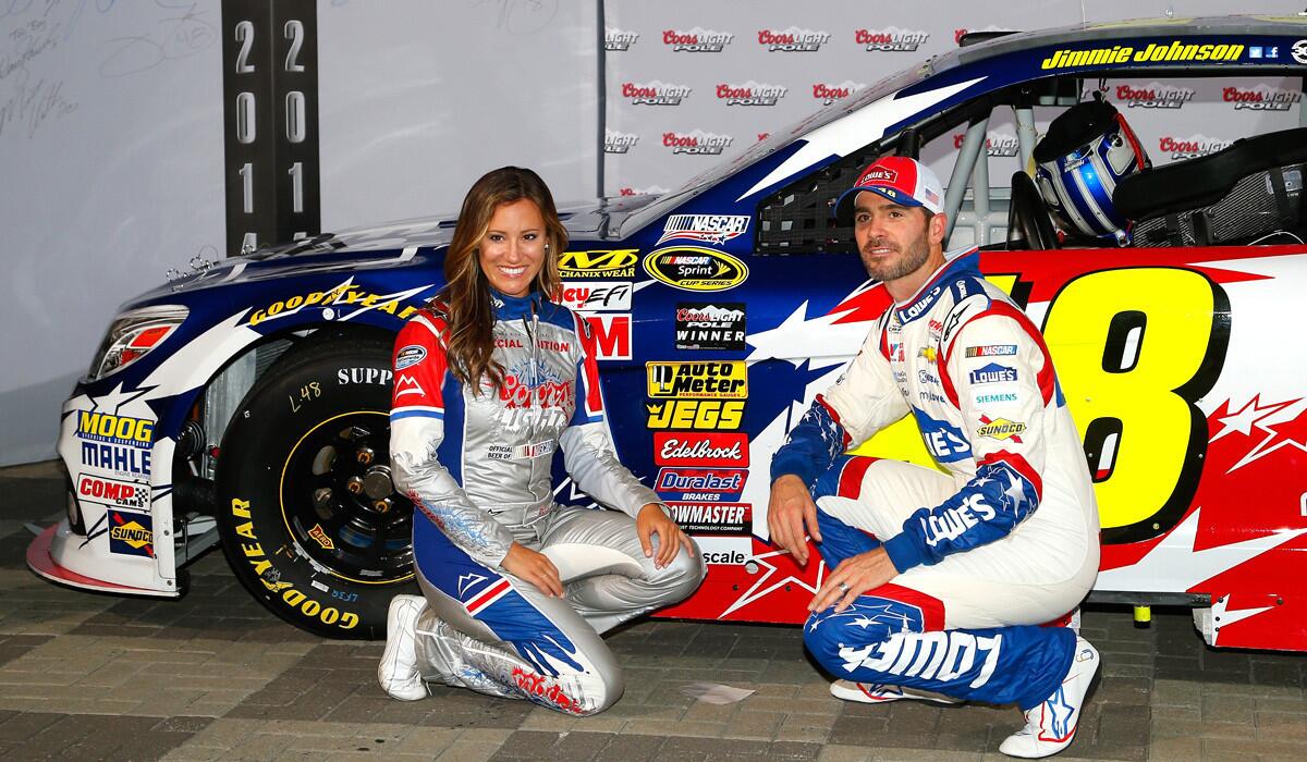 NASCAR driver Jimmie Johnson poses with Rachel Rupert, Miss Coors Light, on Thursday after winning the pole position for the Sprint Cup Series Coca-Cola 600 at Charlotte Motor Speedway.