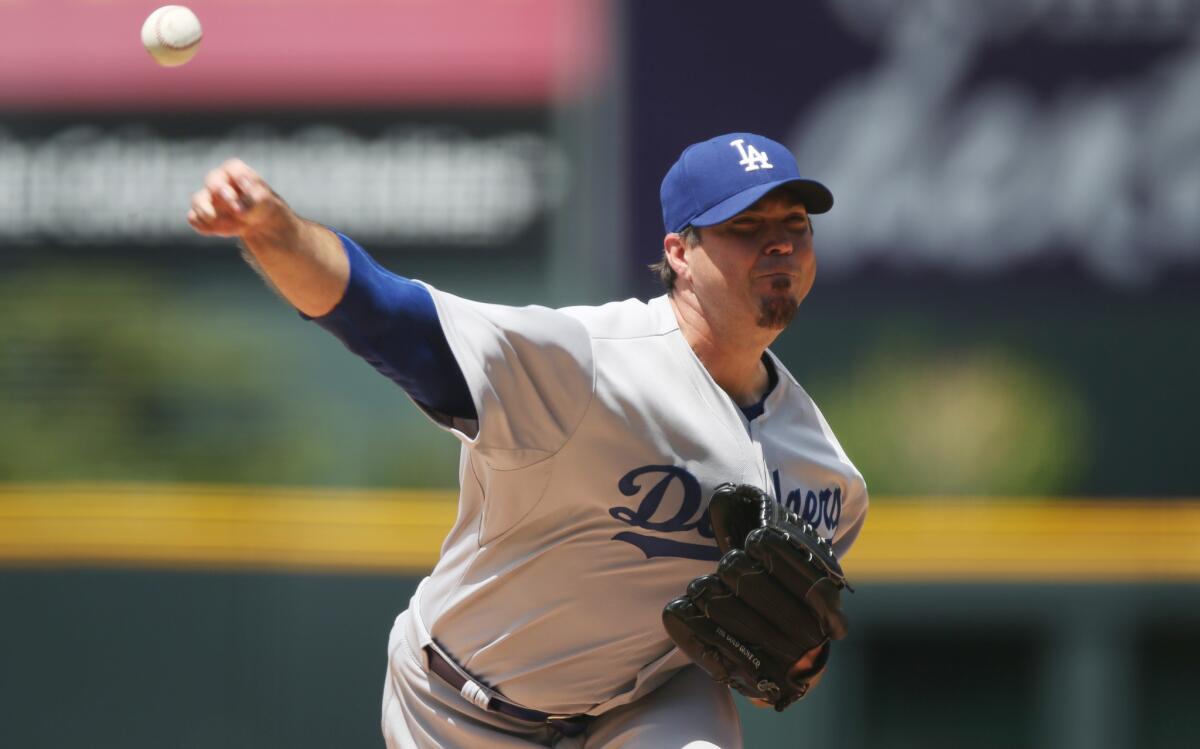 Dodgers starting pitcher Josh Beckett works against the Colorado Rockies on July 6.