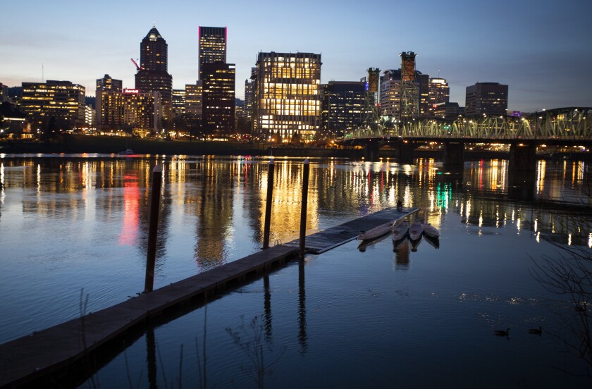 A river, a bridge and a city skyline in the dark