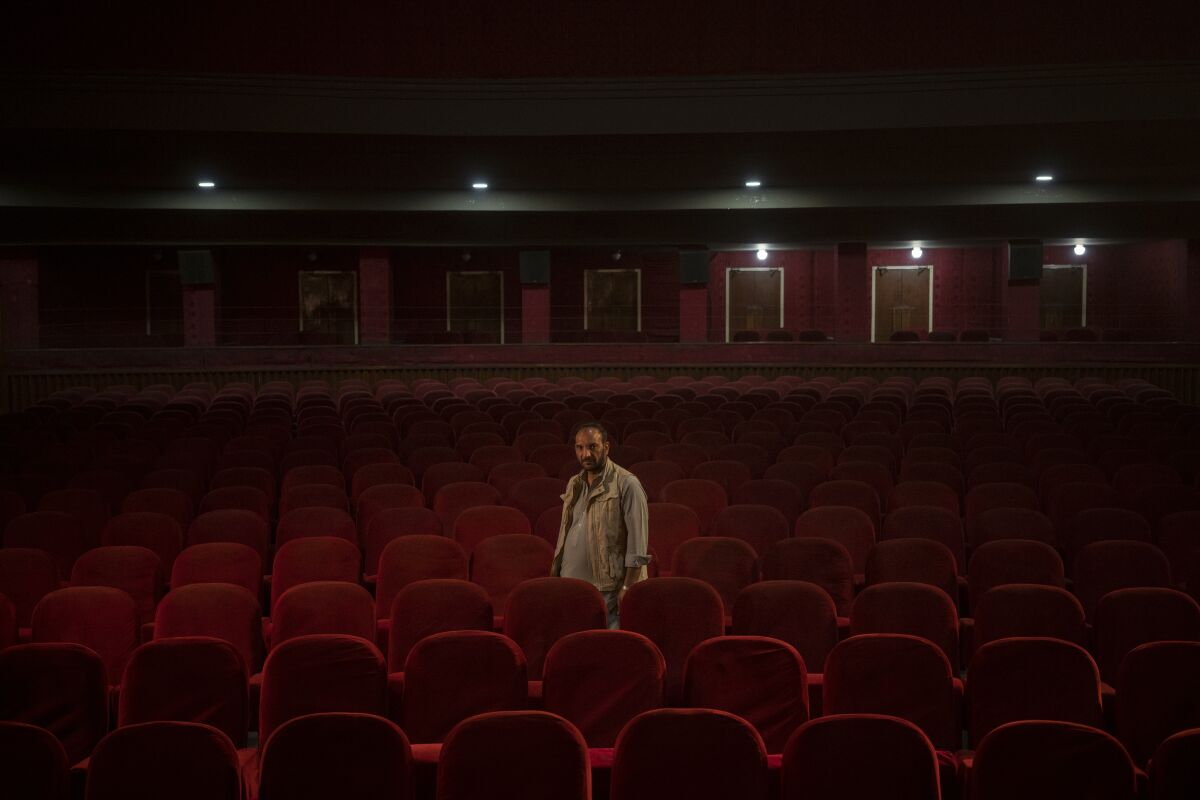Man standing in an empty movie theater