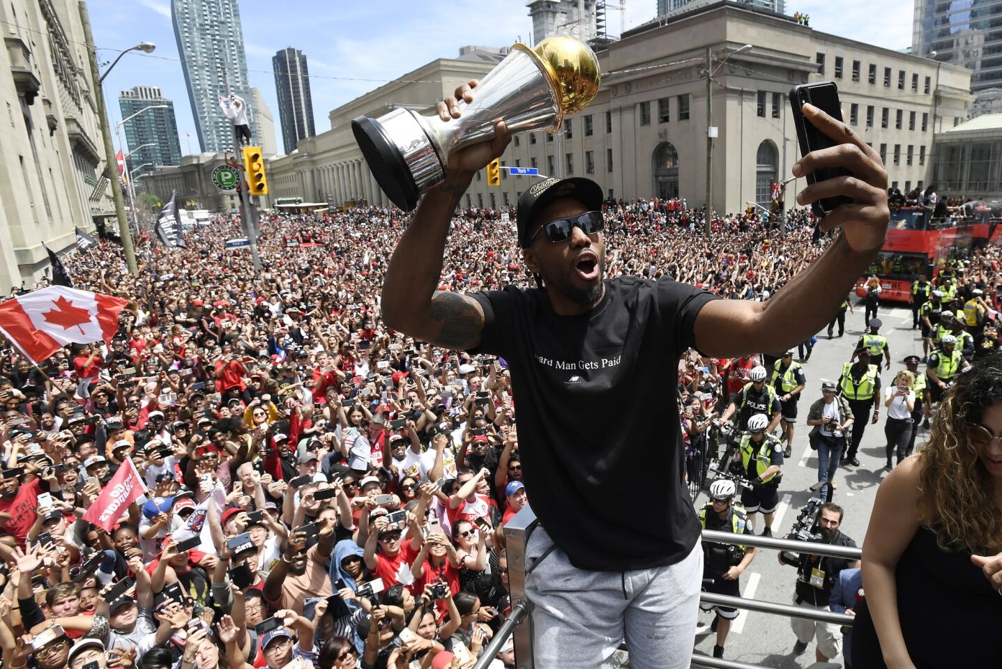 Toronto Raptors forward Kawhi Leonard takes a selfie holding his playoffs MVP trophy during the NBA