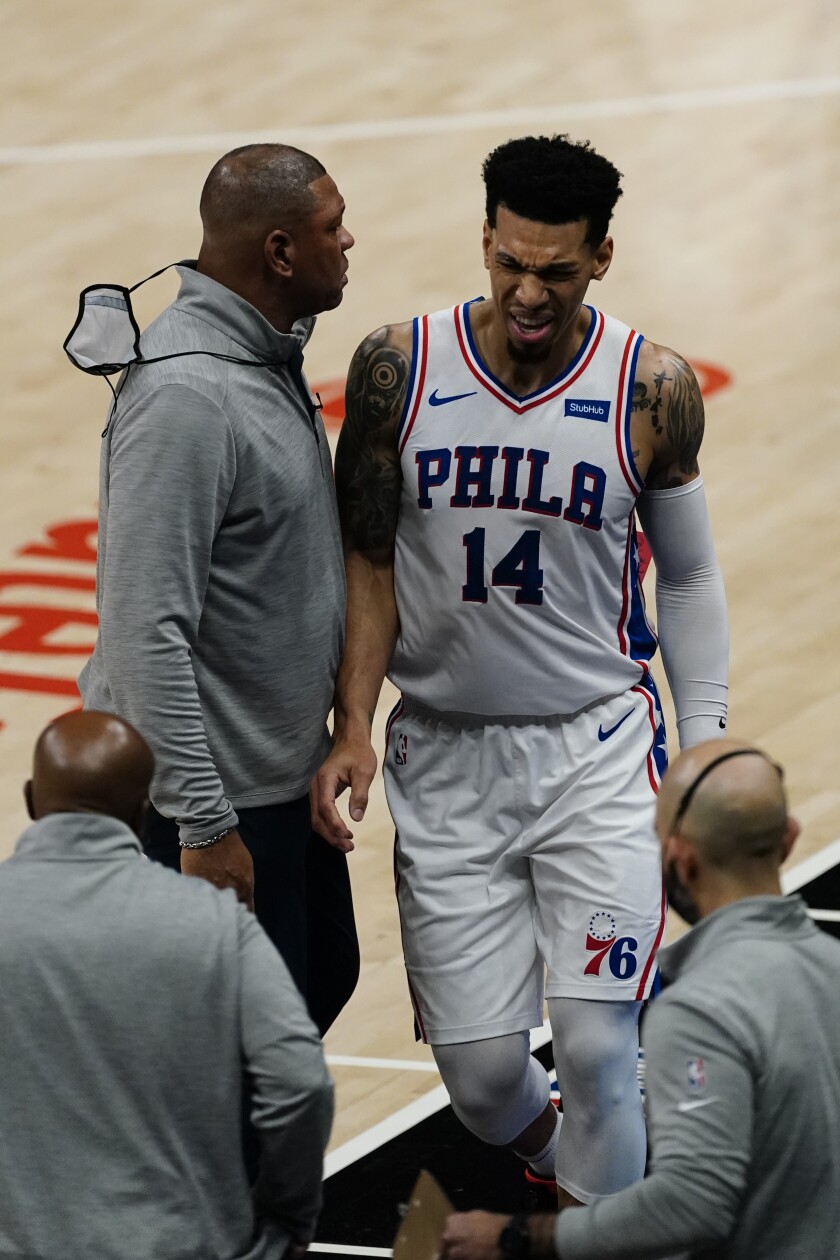 Philadelphia 76ers forward Danny Green (14) reacts as he walks off the court past head coach Doc Rivers, top left, before heading to the locker room, during the first half of Game 3 of a second-round NBA basketball playoff series against the Atlanta Hawks, Friday, June 11, 2021, in Atlanta. (AP Photo/John Bazemore)