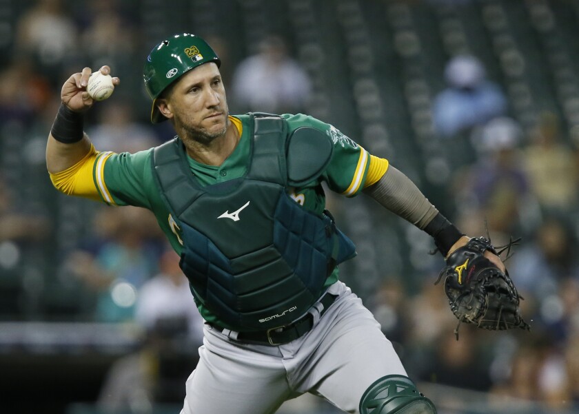 FILE - Oakland Athletics catcher Yan Gomes throws out Detroit Tigers' Dustin Garnea at first base on a chopper in front of home plate during the sixth inning of a baseball game Tuesday, Aug. 31, 2021, in Detroit. The Chicago Cubs added another catcher on Tuesday, Nov. 30, agreeing to a $13 million, two-year contract with Yan Gomes. A person with direct knowledge of the contract confirmed the deal to The Associated Press on Tuesday on condition of anonymity because it had not been finalized. (AP Photo/Duane Burleson, File)
