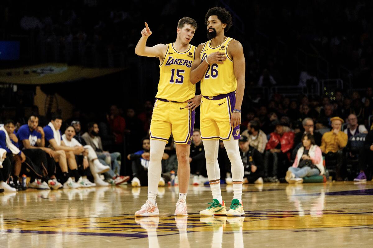 Lakers guard Austin Reaves (15) gives offensive play information to recently acquired Lakers guard Spencer Dinwiddie (26).