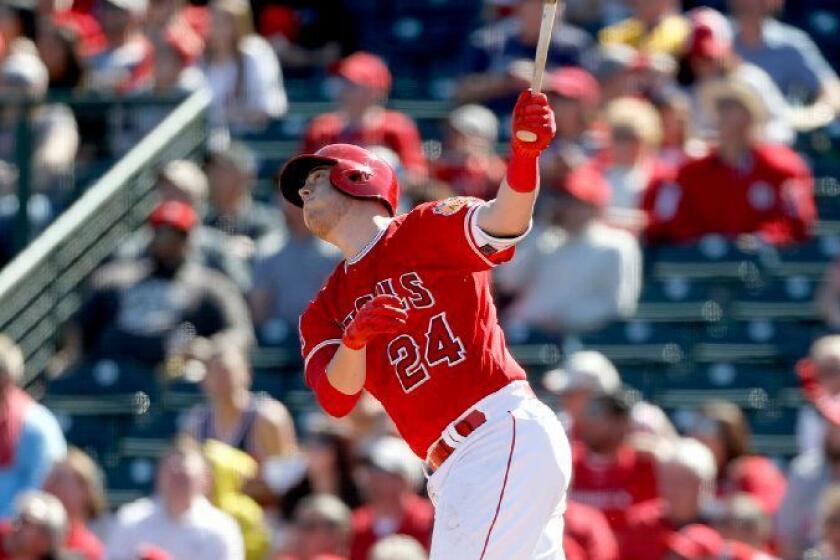 Angels first baseman C.J. Cron watches the flight of the ball during a spring training game against the Brewers on Feb. 25.