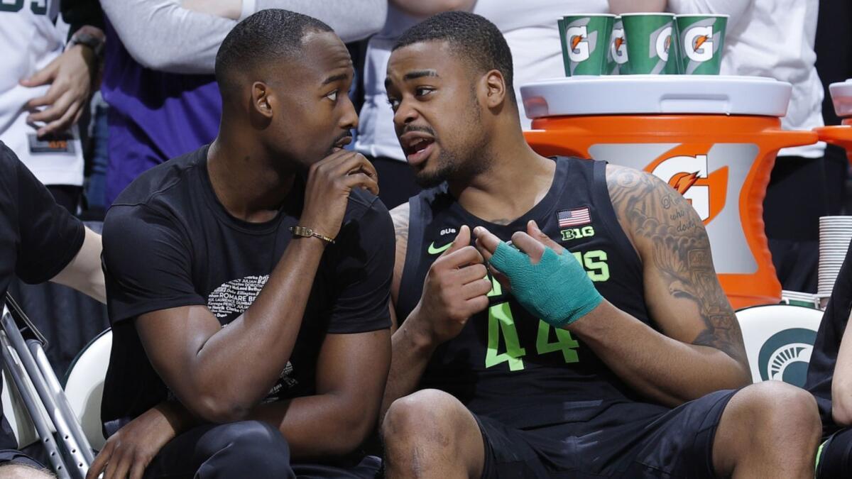 Michigan State's Nick Ward, right, talks with Joshua Langford during the second half Sunday.