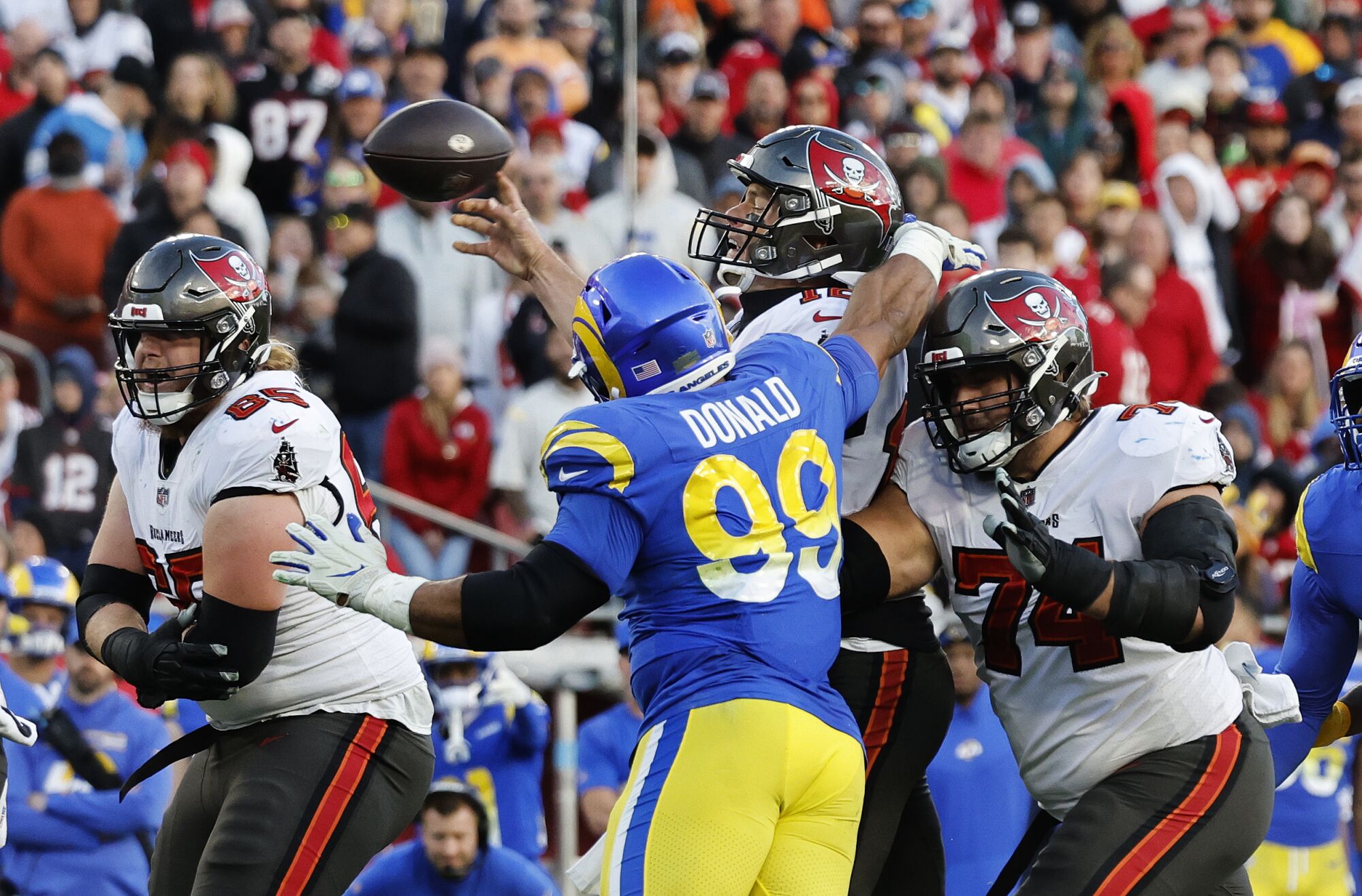 Los Angeles Rams defensive end Aaron Donald (99) gets to Tampa Bay Buccaneers quarterback Tom Brady