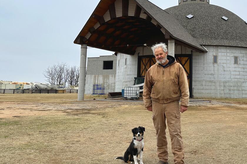 jay branson in front of his barn