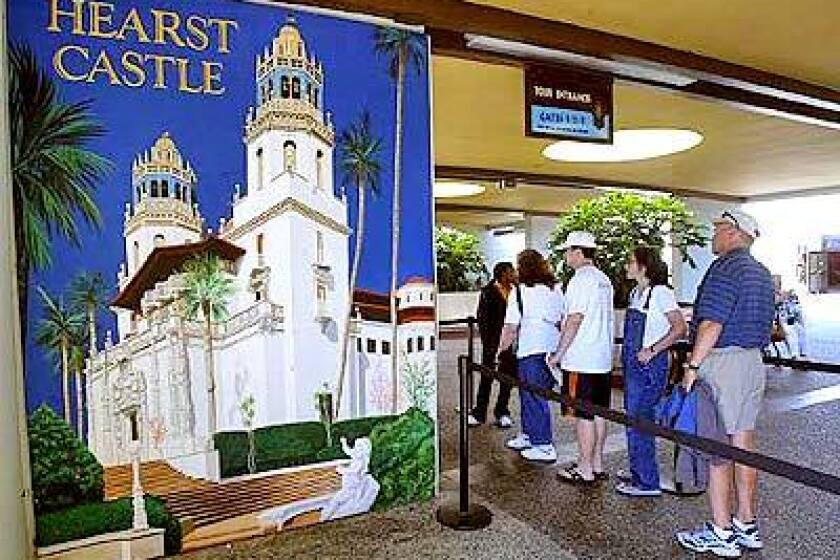 Tourists wait to ride a bus up the hill to tour Hearst Castle in San Simeon on the Central Coast.