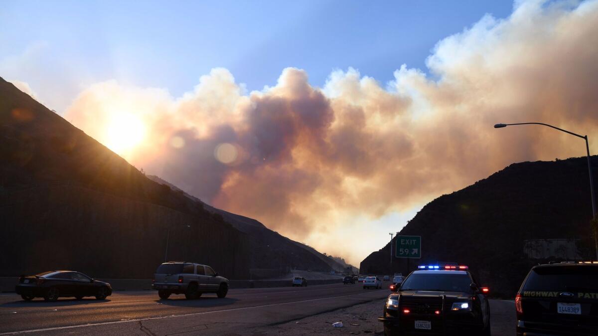 Smoke from the Skirball fire rises above the 405 Freeway near Bel-Air on Dec. 6.