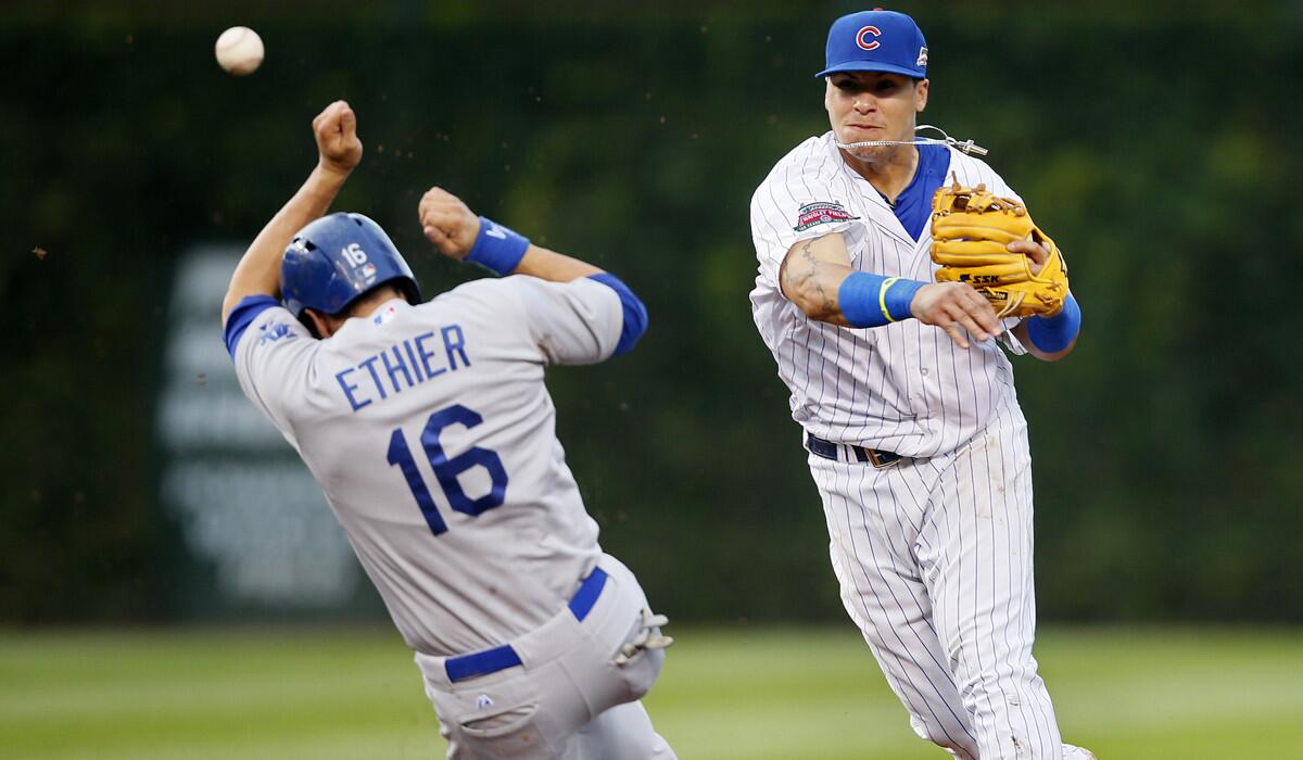 Chicago Cubs shortstop Javier Baez throws to first base after forcing out Dodgers pinch-hitter Andre Ethier to complete a double play in the eighth inning Saturday afternoon at Wrigley Field.