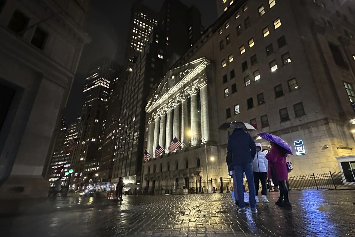 People huddle outside the New York Stock Exchange 
