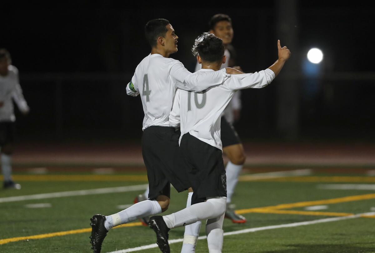 Century's Victor Orozco, left, congratulates Gerardo Torres on his goal scored against Estancia during the first half of a nonleague match on Wednesday.