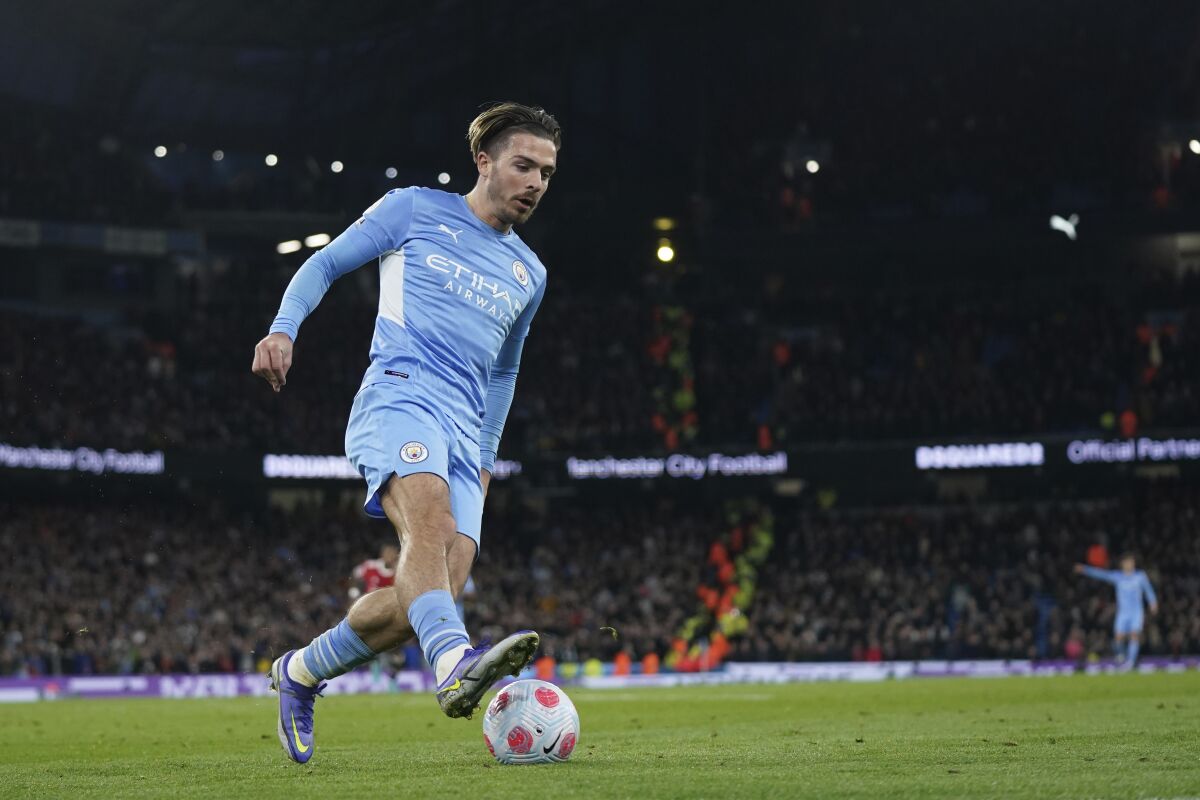 Manchester City's Jack Grealish runs with the ball during the English Premier League soccer match between Manchester City and Manchester United, at the Etihad stadium in Manchester, England, Sunday, March 6, 2022. (AP Photo/Jon Super)