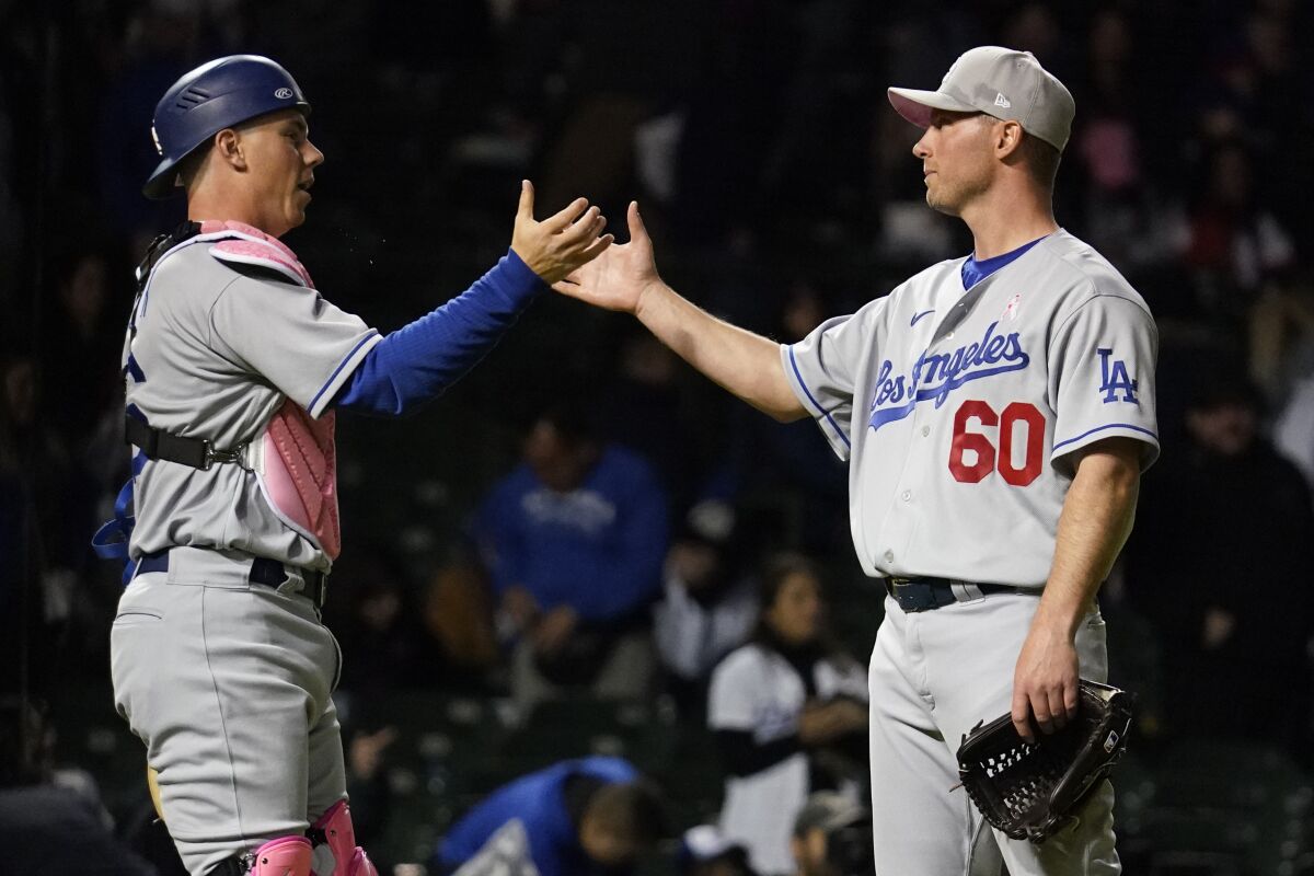 Dodgers catcher Will Smith, left, celebrates with relief pitcher Robbie Erlin after a 7-1 win over the Chicago Cubs.