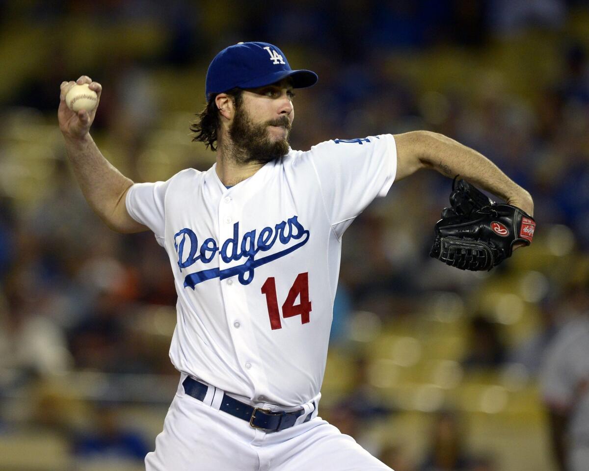 Dodgers pitcher Dan Haren hit the 180-inning mark for the season Monday night, which automatically vested his option to pitch in 2015 for $10 million.