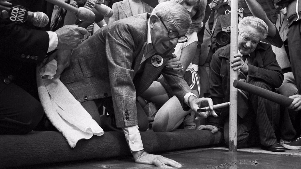 George Burns makes a hand print in cement outside Mann's Chinese Theatre on January 25, 1979.