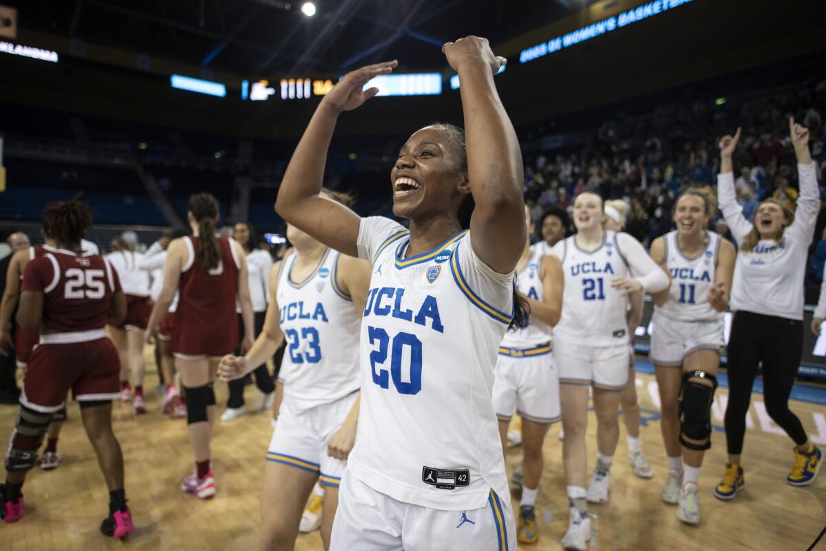 UCLA's Charisma Osborne waves her arms toward the stands and grins after defeating Oklahoma during the NCAA tournament