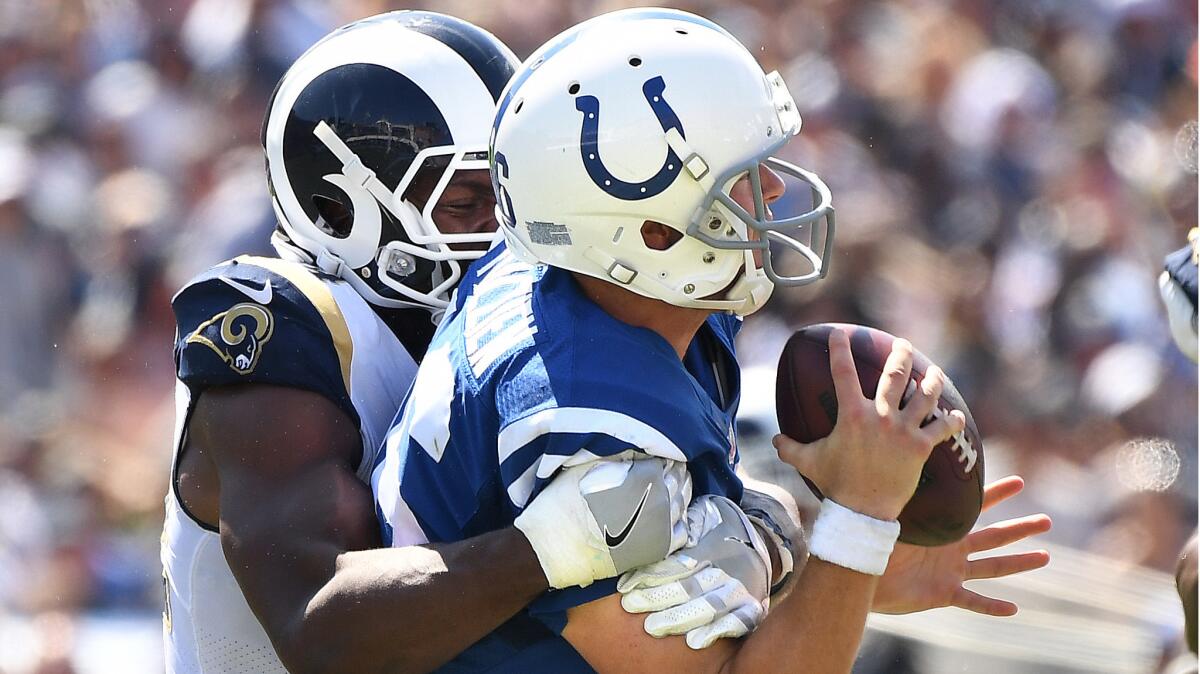 Rams defensive end Robert Quinn sacks Colts quarterback Scott Tolzien during the second quarter.