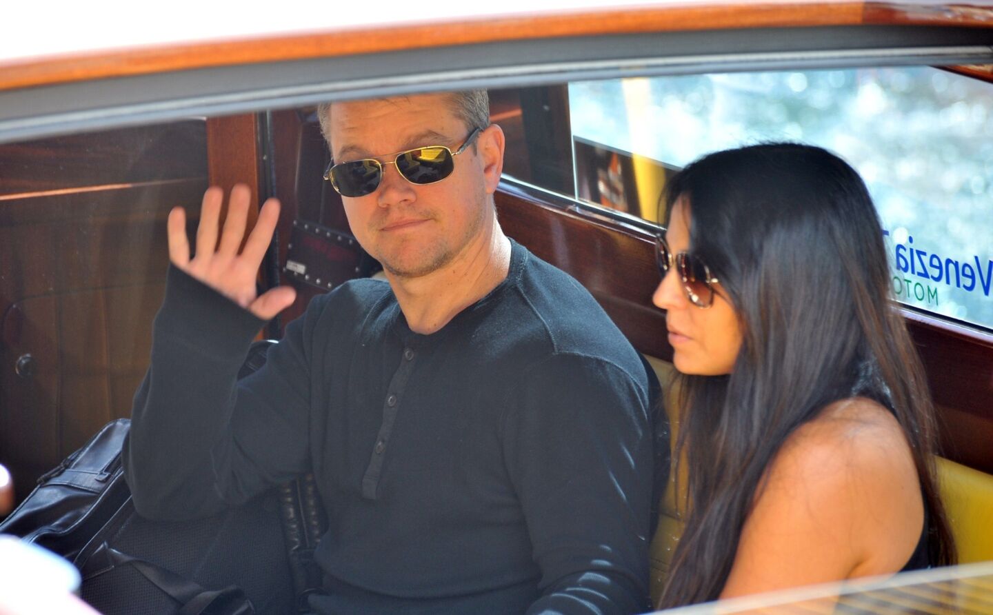 Matt Damon, with wife Luciana Barroso, wasn't avoiding the photographers as they arrived for George Clooney and Amal Alamuddin's wedding weekend.
