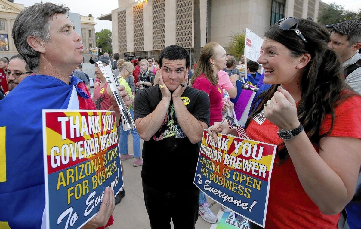 Protesters celebrate outside the Arizona Capitol in Phoenix after Gov. Jan Brewer vetoed SB 1062.