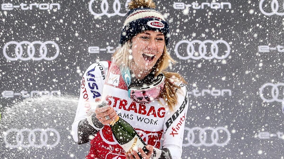 Mikaela Shiffrin celebrates her slalom victory on Saturday amidst the snow and spraying of bubbly.