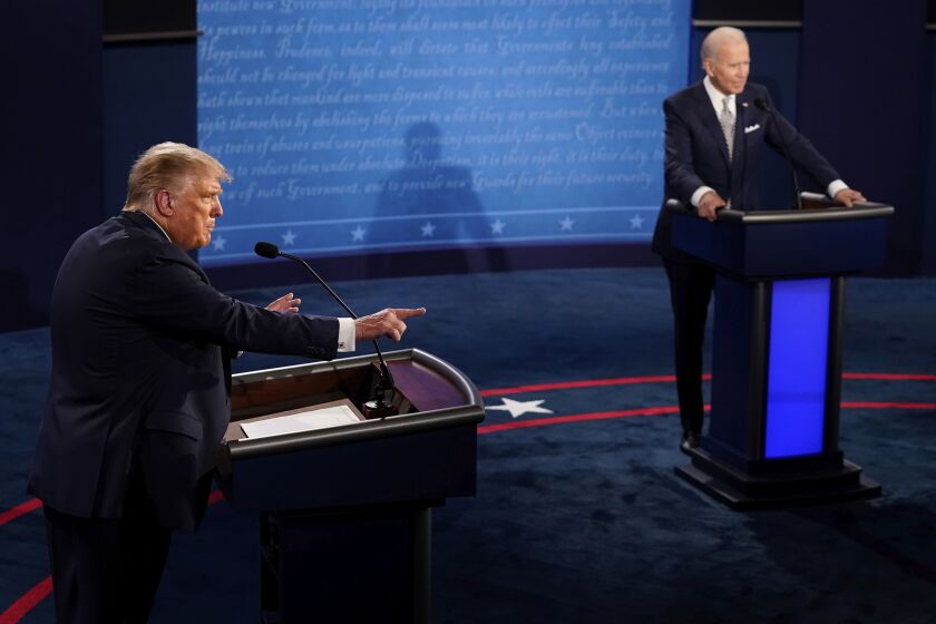 President Donald Trump makes a points as Democratic presidential candidate former Vice President Joe Biden listens during the first presidential debate Tuesday, Sept. 29, 2020, at Case Western University and Cleveland Clinic, in Cleveland, Ohio. (AP Photo/Morry Gash, Pool)