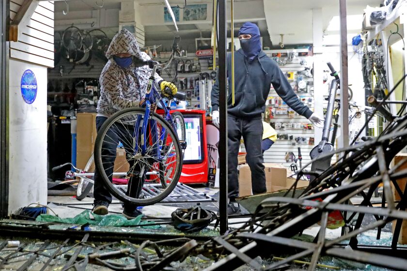 LOS ANGELES, CA -- MAY 30: Looters and vandals ransack Spokes 'N Stuff at Melrose Ave. and Ogden Dr. in the Melrose District on Saturday, May 30, 2020, in Los Angeles, CA. Several businesses on Melrose Avenue, a trendy row of design and clothing stores, were looted. Earlier in the day protestors demonstrated at the corner of Fairfax and 3rd Street in response to the death of George Floyd in Minnesota. More than 500 arrests after looting and vandalism sweep downtown L.A. (Gary Coronado / Los Angeles Times)