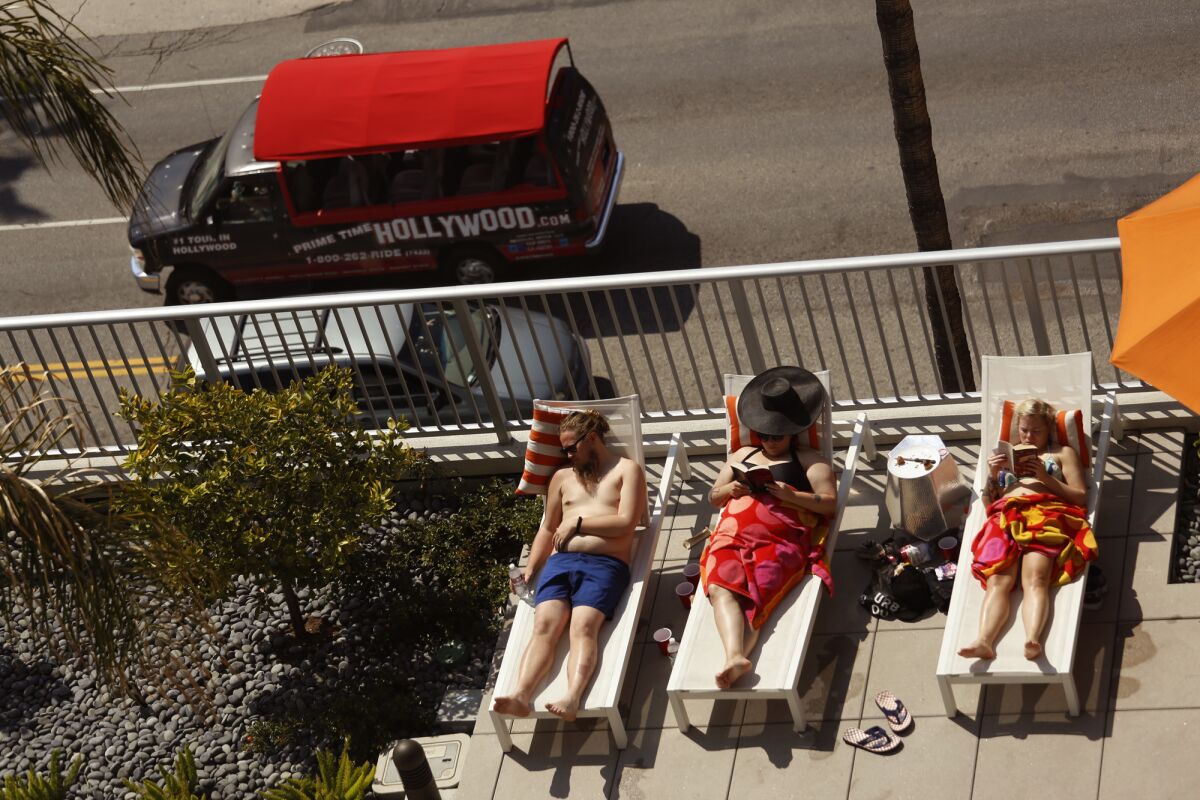 Visitors sun themselves poolside at the Sunset and Gordon building in Hollywood on April 11, 2015.
