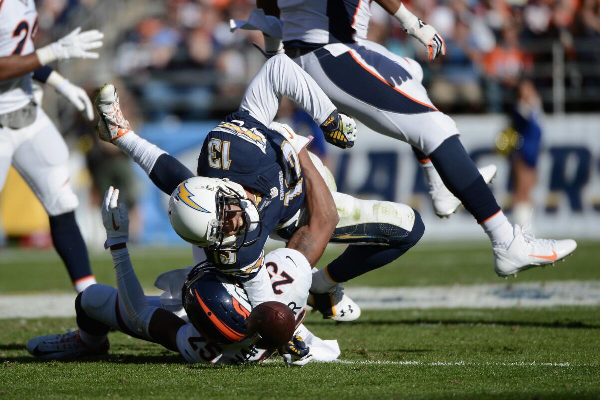 Receiver Keenan Allen makes a catch in front of Broncos cornerback Chris Harris during a game on Dec. 14, 2014.