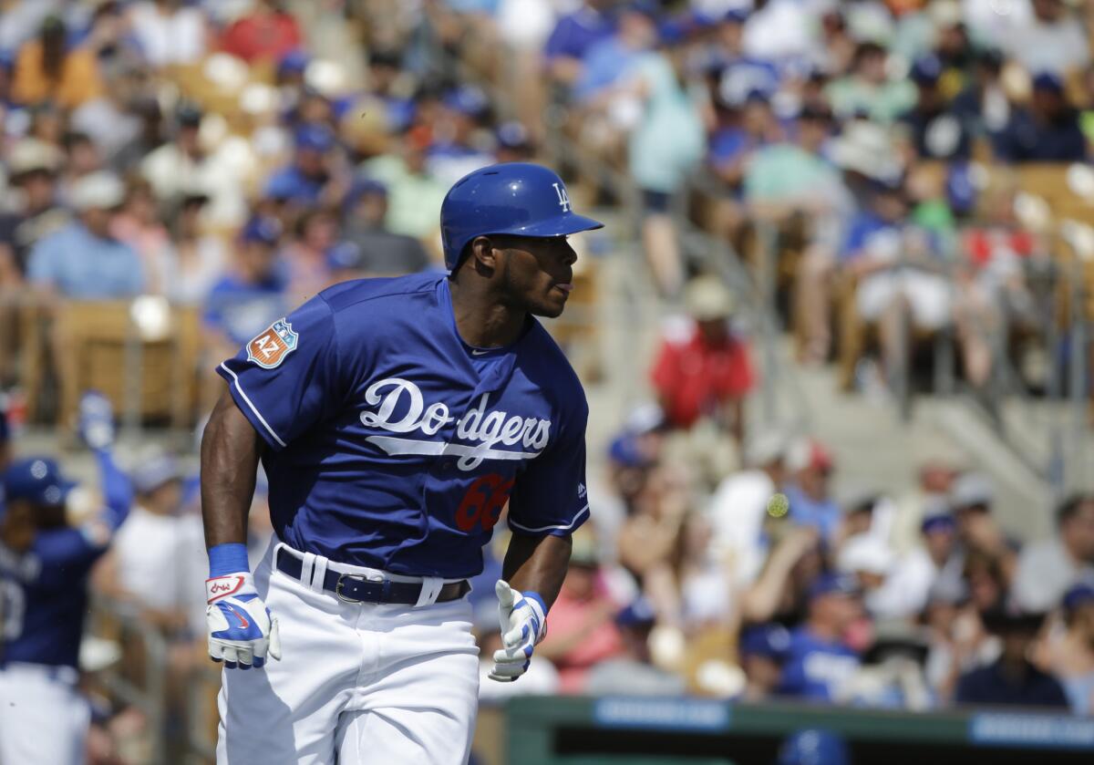 Dodgers outfielder Yasiel Puig runs to first base during a spring training game against the Mariners on March 21.