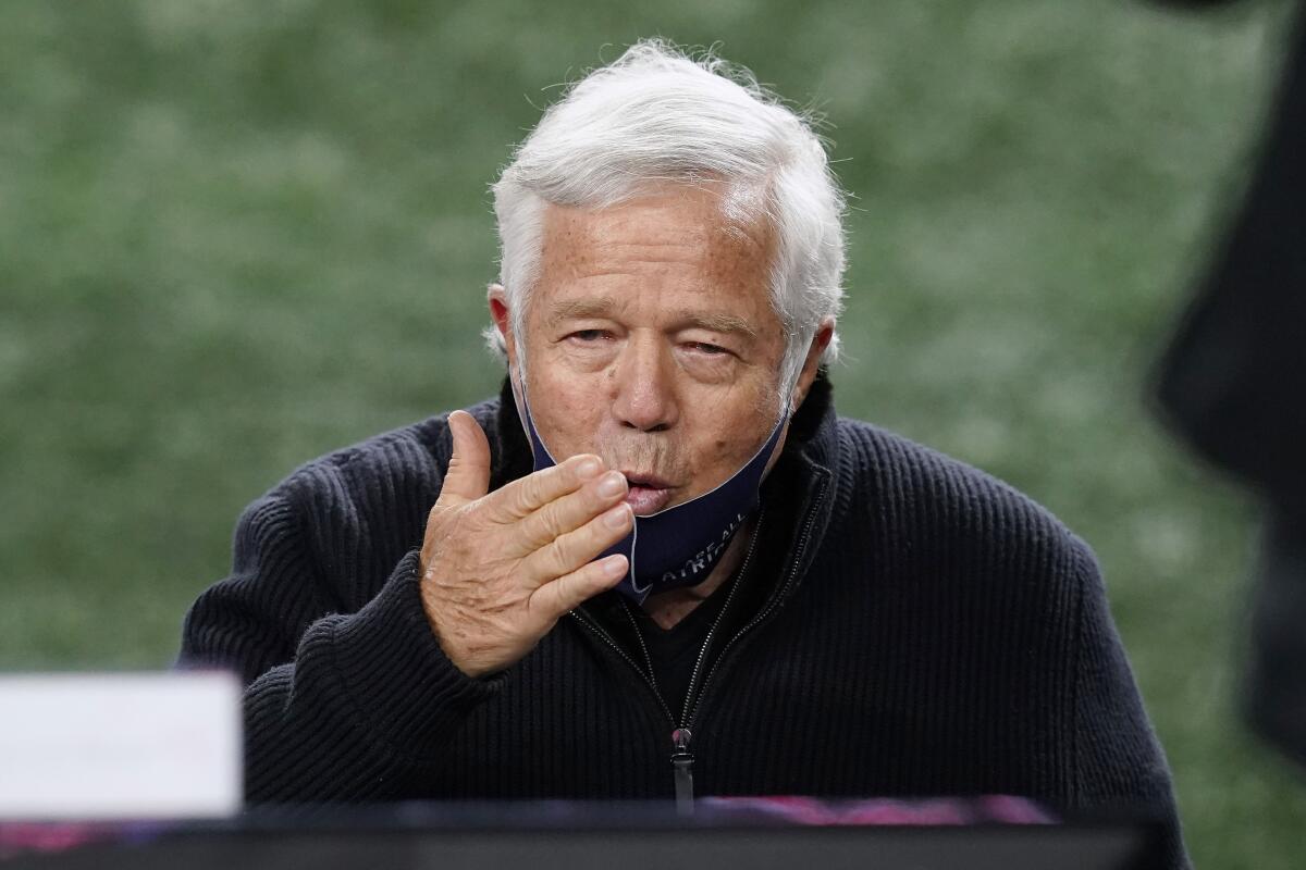 Robert Kraft blows a kiss to someone before a game.