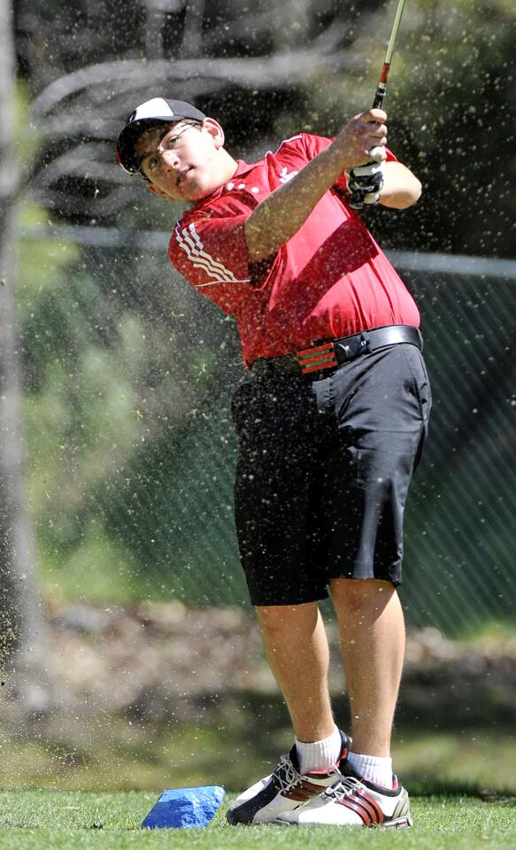 Burroughs' Daniel Kesicbasian tees off on the third in a Pacific League golf match with Burbank, Crescenta Valley, Glendale, Burroughs, and Arcadia at the De Bell Golf Course in Burbank on Thursday, March 14, 2013.