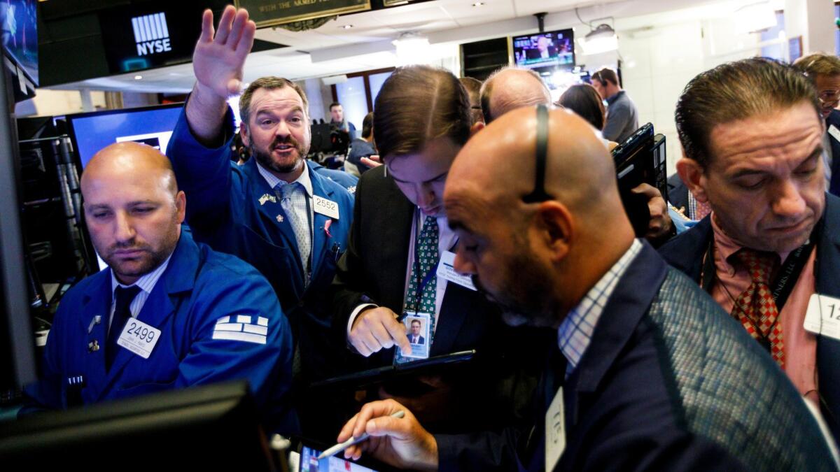 Traders work on the floor of the New York Stock Exchange.