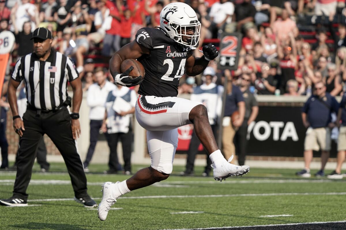 Cincinnati running back Jerome Ford (24) runs into the end zone for a touchdown during the second half of an NCAA college football game against Murray State, Saturday, Sept. 11, 2021, in Cincinnati. (AP Photo/Jeff Dean)