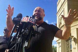 Alex Jones addresses the media outside a courthouse in Waterbury, Conn., on Sept. 21.