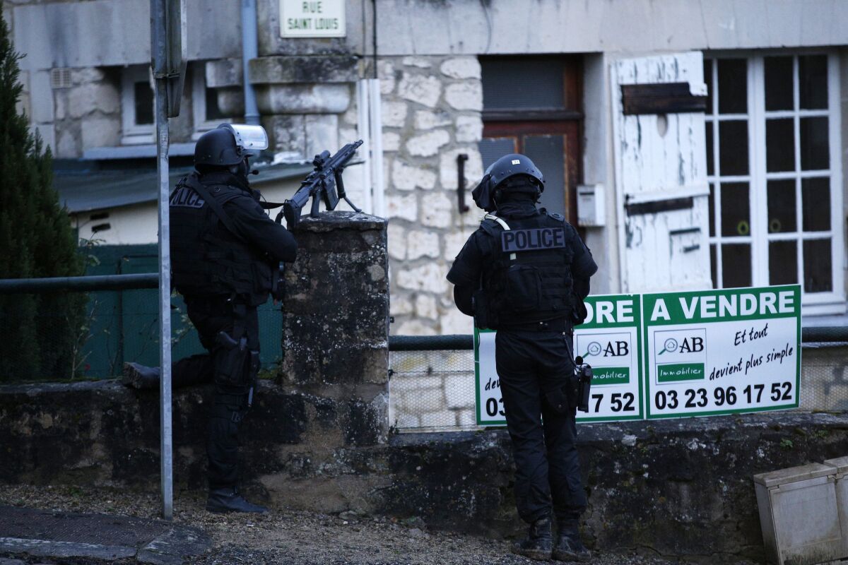 Police patrol during Friday's manhunt for the suspects in the shooting attack at a French newspaper this week.