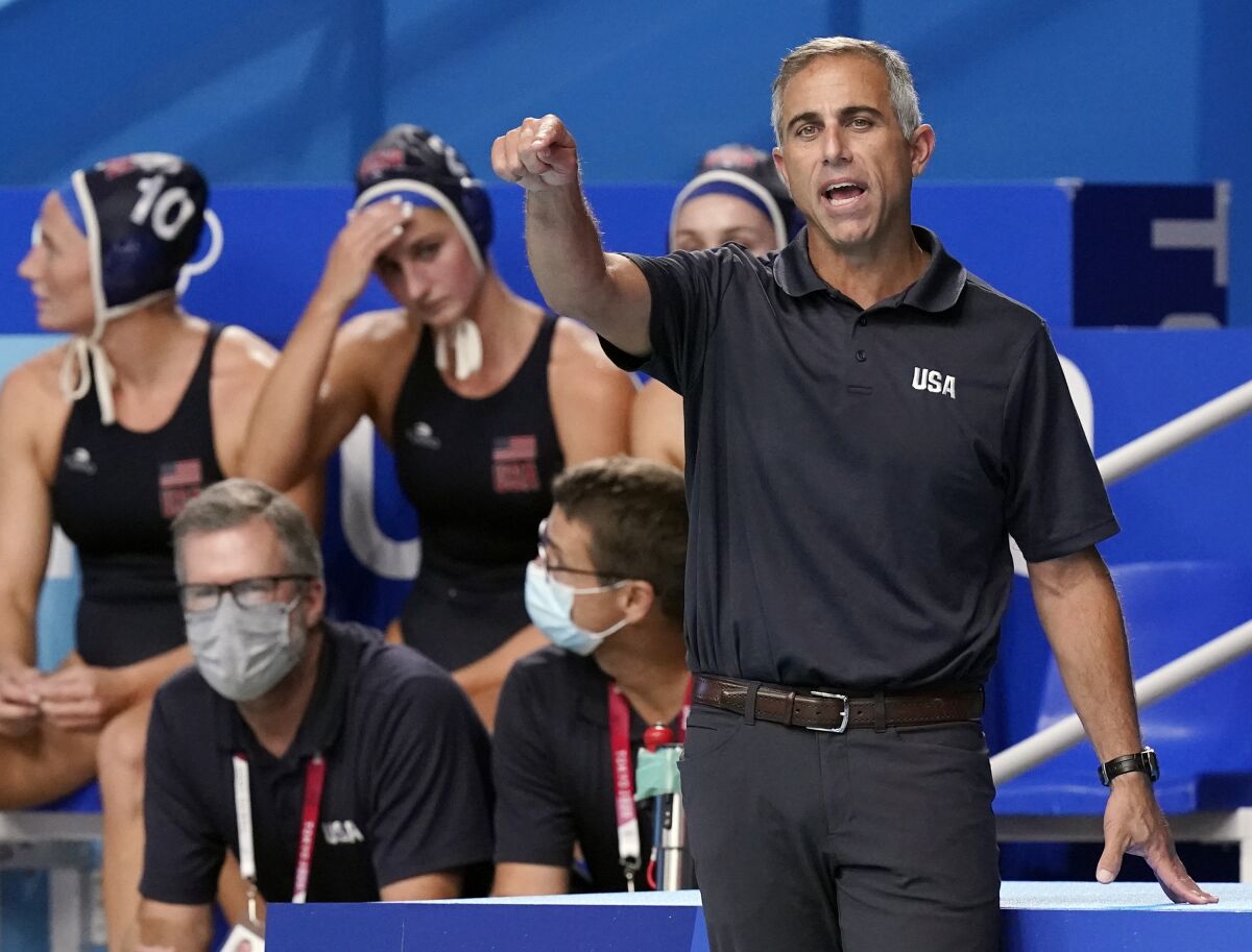 FILE - United States head coach Adam Krikorian, right, directs players during a quarterfinal round win over Canada in a women's water polo match at the 2020 Summer Olympics, Aug. 3, 2021, in Tokyo, Japan. Right after the Summer Olympics, Krikorian was done. Worn down by coaching the U.S. women's water polo team through a pandemic, he thought it might be time to try something new. (AP Photo/Mark Humphrey, File)