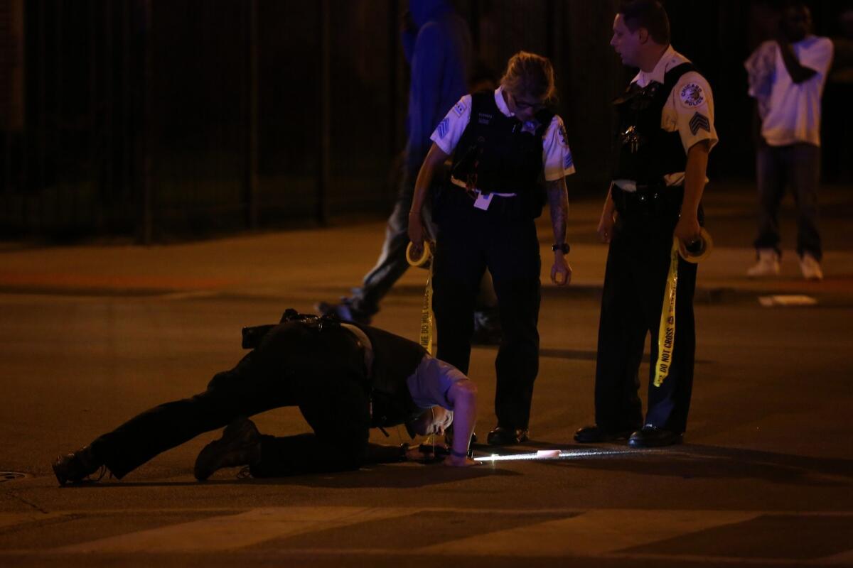 Chicago police investigate the scene of a shooting earlier this summer.