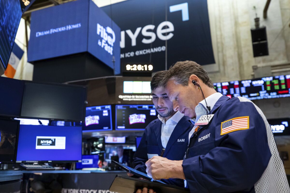 Two traders work on the floor of the New York Stock Exchange.